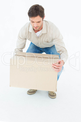Delivery man picking cardboard box