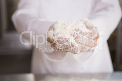 Close up of bakers hands holding flour