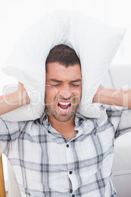 Screaming man with a pillow