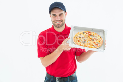 Happy delivery man showing fresh pizza