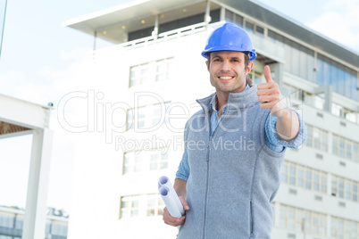 Happy male architect gesturing thumbs up