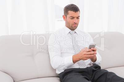 Businessman sending a his text i