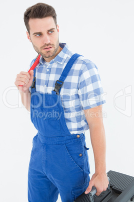 Repairman carrying toolbox while looking asway