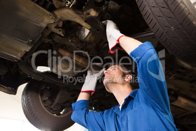 Mechanic examining under the car