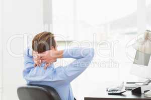 Businessman relaxing in a swivel chair leaning back