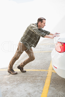 Man pushing his broken down car