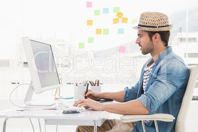 Casual designer using computer and digitizer
