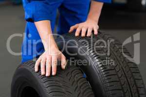 Mechanic rolling a tire wheel