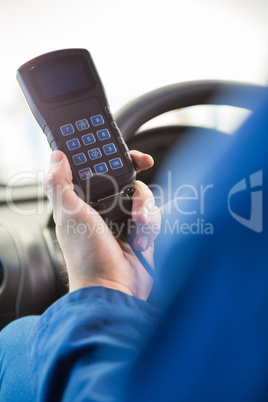 Mechanic using diagnostic tool in the car