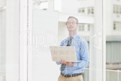 Serious businessman using laptop