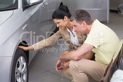 Businesswoman and customer discussing details of car tire