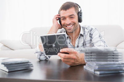 Smiling man listening to cds