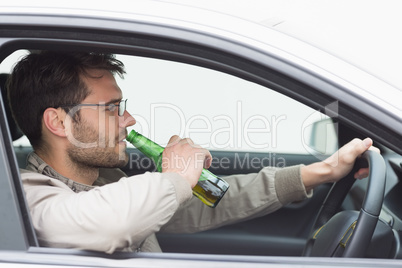 Man drinking beer while driving