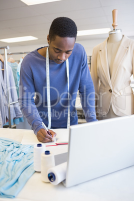 Cheerful university student writing on notebook Cheerful university student writing on notebook