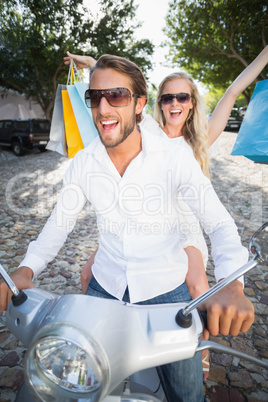 Attractive couple riding a scooter