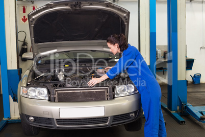 Mechanic working under the hood