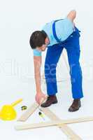 Repairman picking up screwdriver while suffering from backache