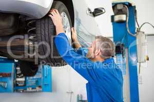 Mechanic adjusting the tire wheel