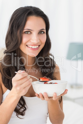 Brunette having breakfast in bed