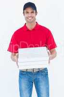 Happy delivery man holding pizza boxes