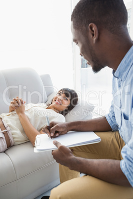 Smiling woman lying talking with her therapist