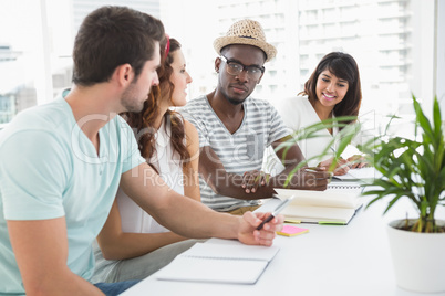 Coworkers sitting and taking notes together