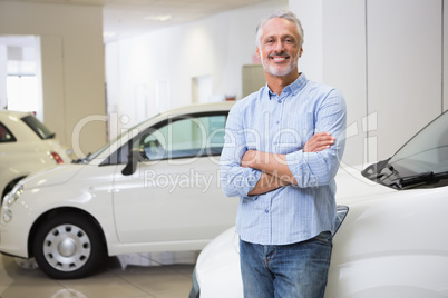 Smiling customer standing with arms crossed