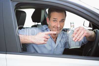Man showing an empty bottle of vodka