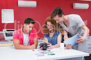 Smiling students working with camera and tablet