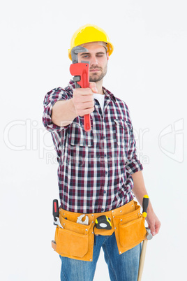 Handyman looking through adjustable wrench