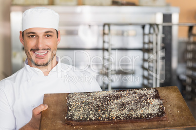 Baker showing freshly baked brownie