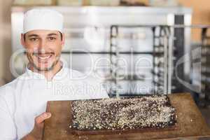 Baker showing freshly baked brownie