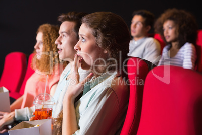 Young friends watching a film