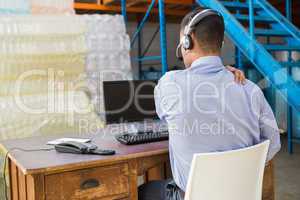 Warehouse manager working on computer