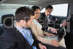 Business team working in the back seat