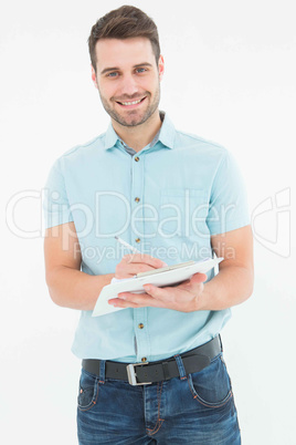 Handome delivery man writing on clipboard