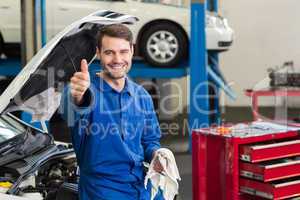 Smiling mechanic looking at camera