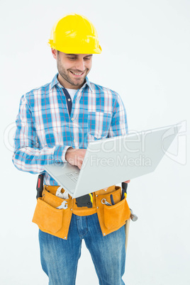 Happy construction worker using laptop Happy construction worker using laptop