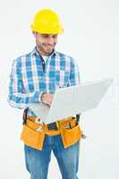 Happy construction worker using laptop