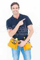 Man with tool belt around waist pointing over white background