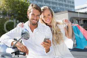 Attractive couple riding a scooter