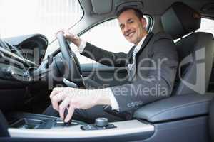 Smiling businessman in the drivers seat