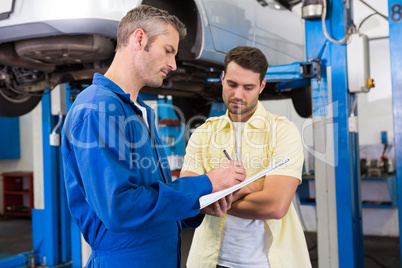 Customer listening to his mechanic