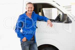 Smiling man leaning against his delivery van