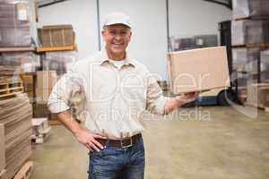 Smiling worker holding cardboard box