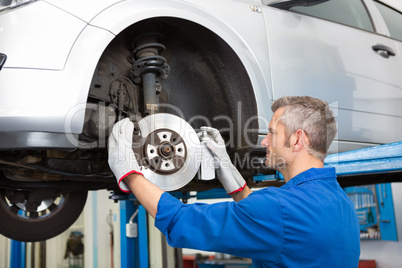 Focused mechanic adjusting the wheel