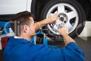 Mechanic adjusting the tire wheel