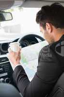 Young businessman reading a map