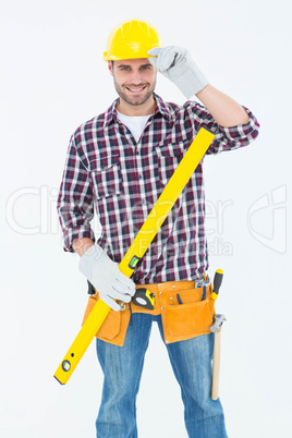 Confident handyman holding spirit level