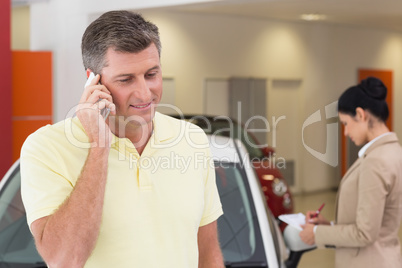 Smiling customer calling with his mobile phone